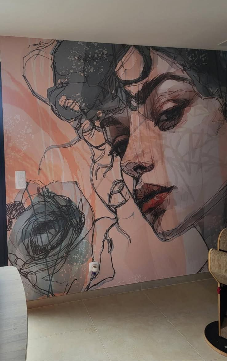 Une fresque murale stylisée présentant un portrait expressif superposé à des dessins abstraits au trait noir sur un fond pêche doux.