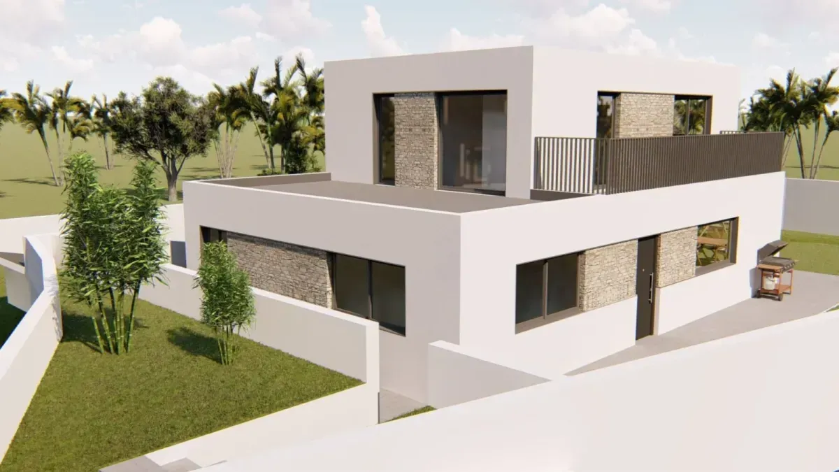 Casa moderna de dos pisos con techo plano, paredes blancas, detalles en piedra, pequeño balcón y un patio con césped.