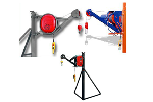Tres cabrestantes motorizados: rojo, azul y negro, cada uno con un control colgante y un cable, montados en diferentes estructuras de soporte.