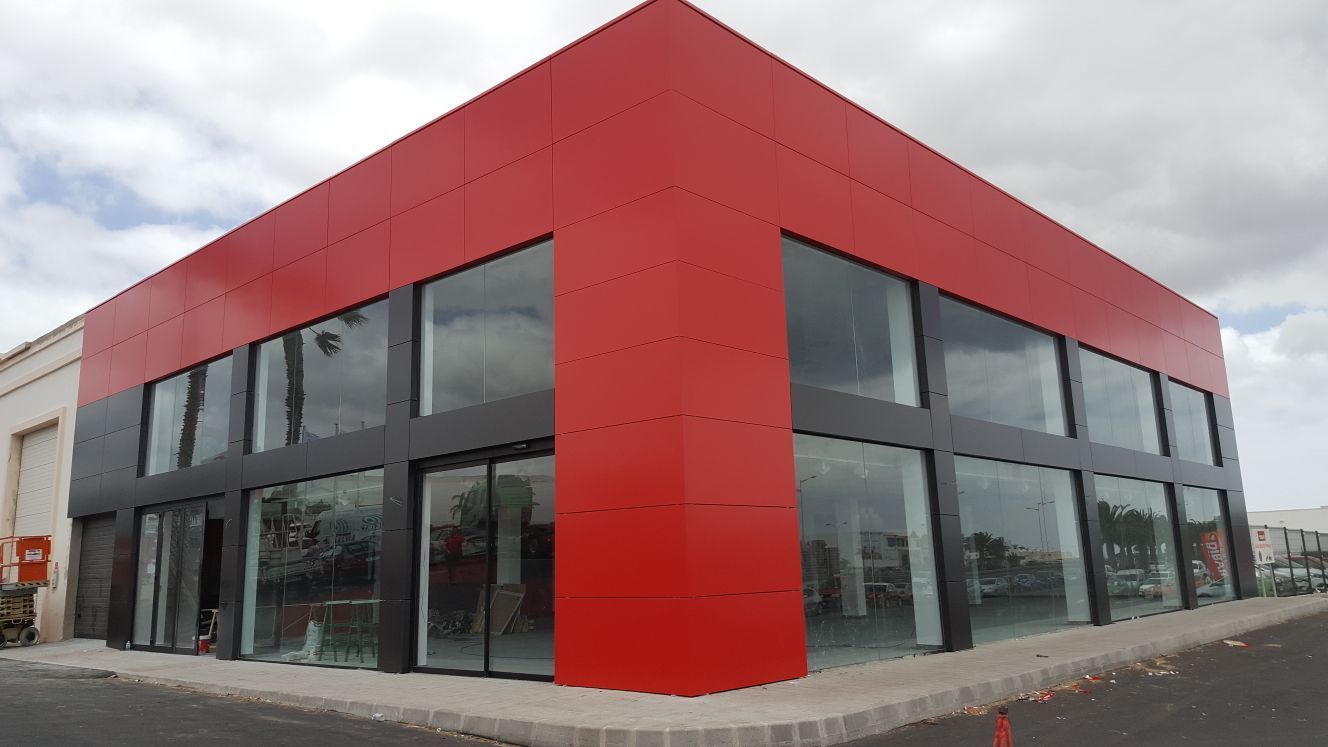 Un edificio rojo y negro con muchas ventanas.