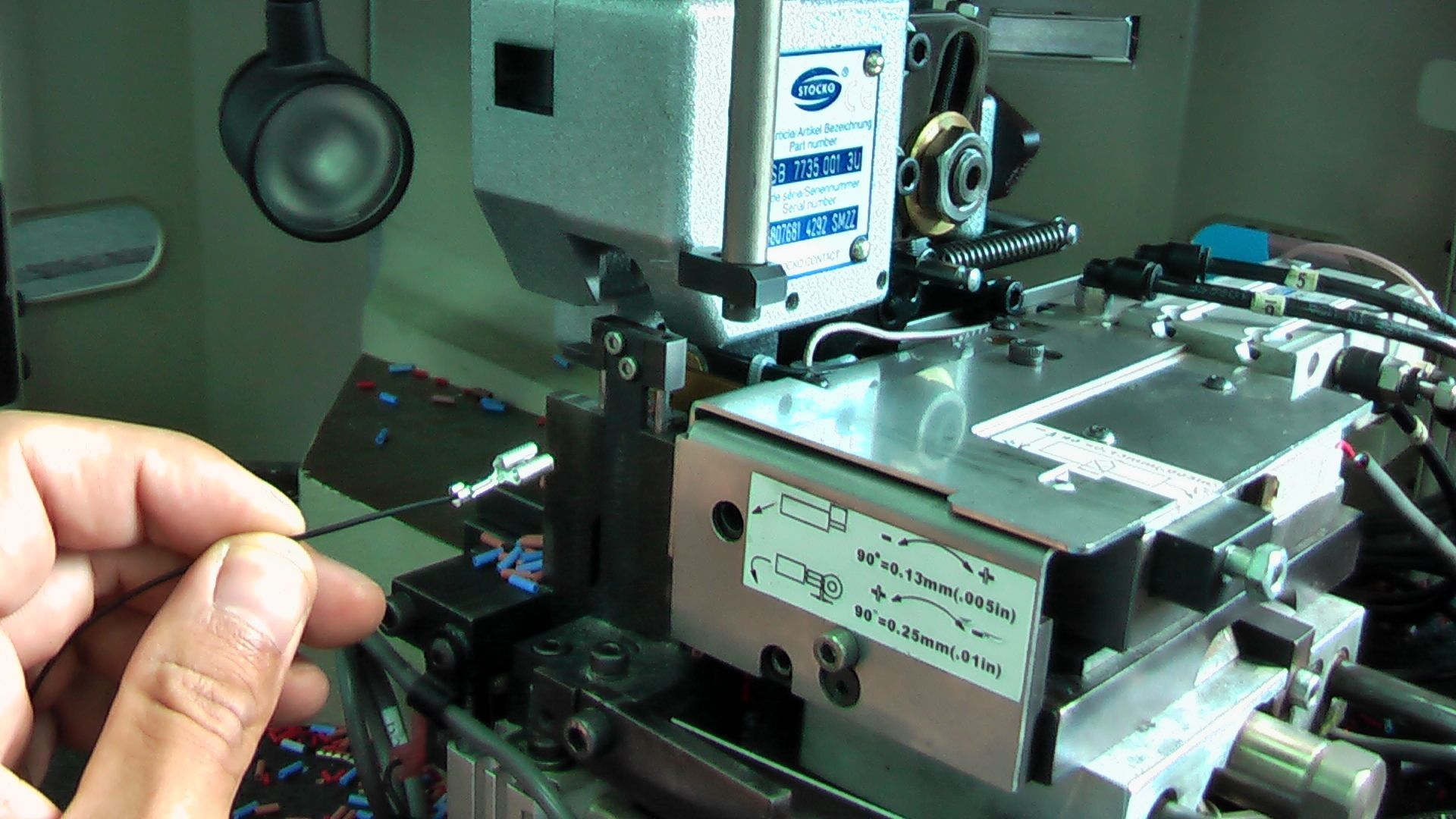 A person is holding a card in front of a machine