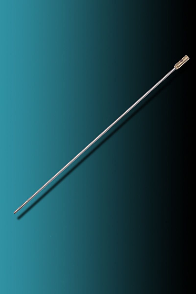 A long needle is sitting on a blue surface.