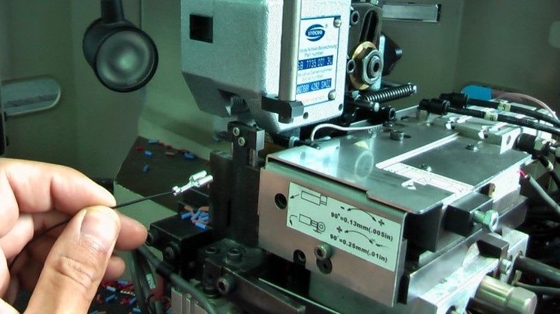 A person is holding a card in front of a machine.