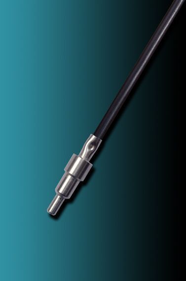 A close up of a metal object on a blue surface.