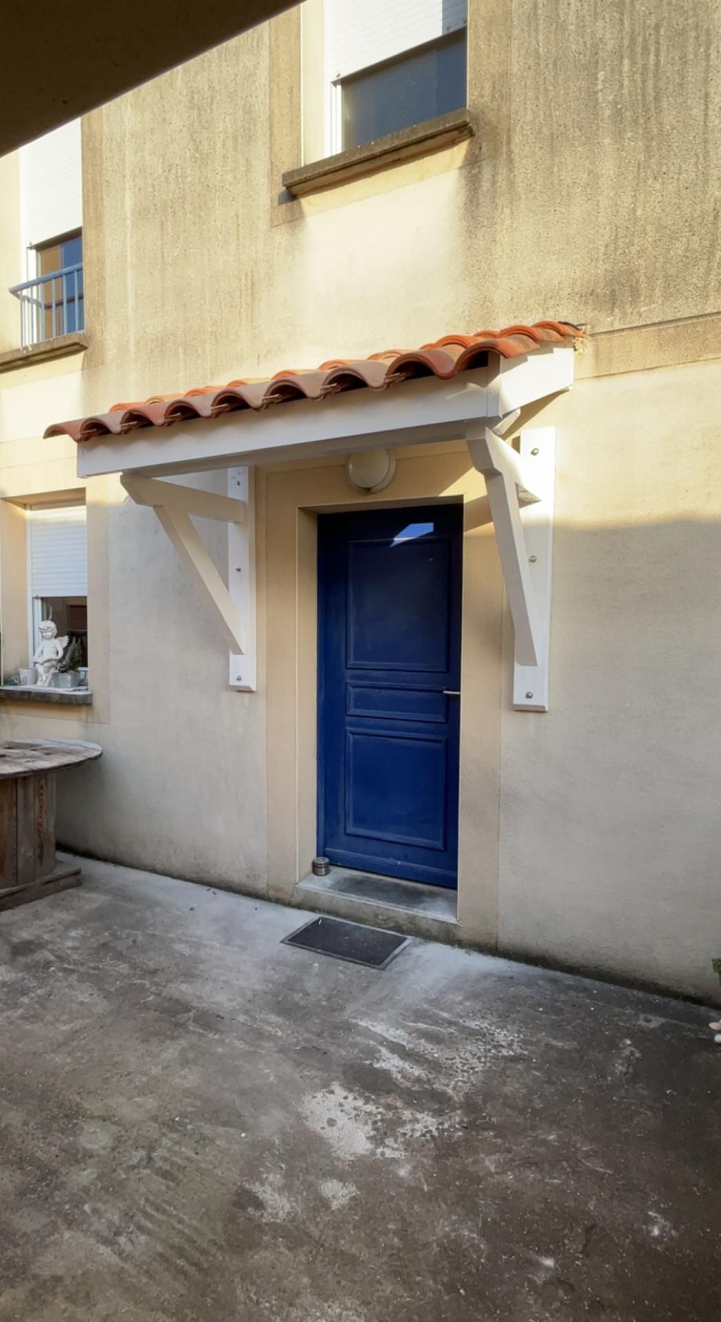 Auvent avec structure en bois peinte en blanc et tuiles