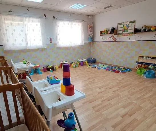 Una habitación llena de muchos juguetes y cunas.