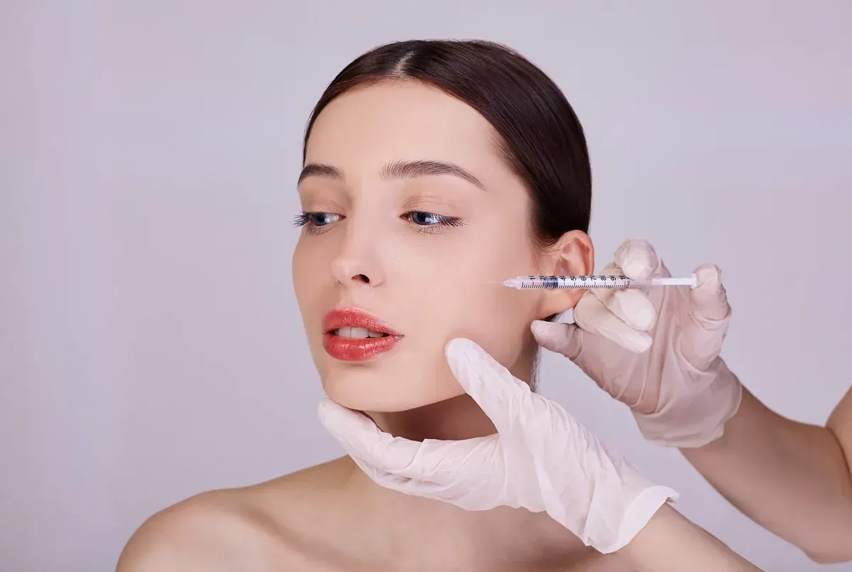 Una mujer recibe una inyección de botox en la cara.