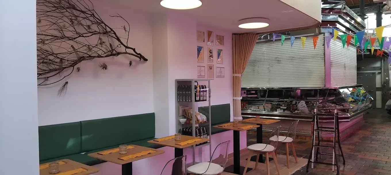 Un restaurante con mesas y sillas en un pasillo.