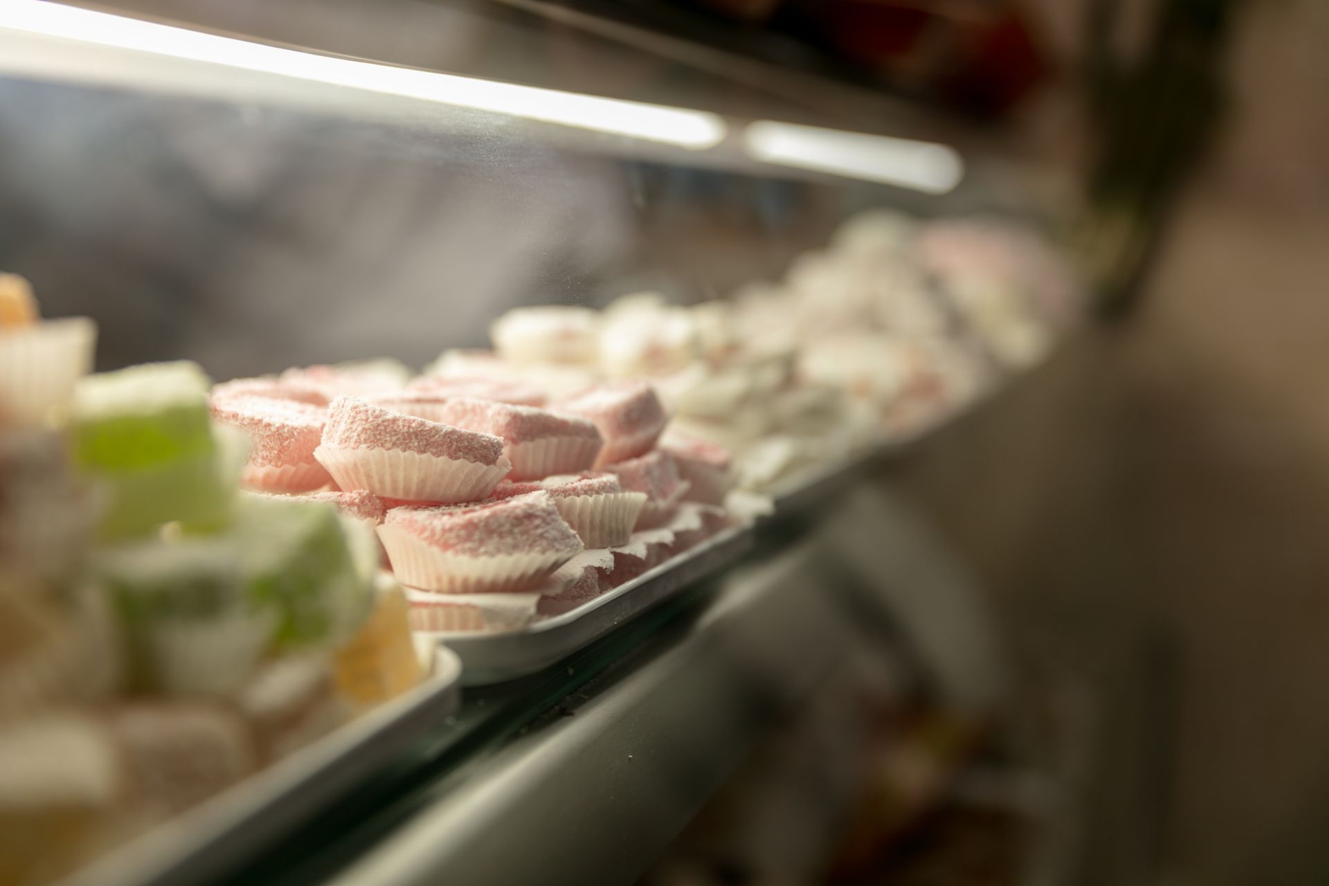 Des desserts, soigneusement empilés dans une vitrine en verre