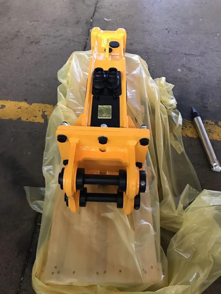 Una máquina amarilla está envuelta en plástico y colocada sobre una mesa.