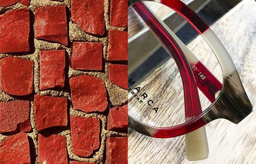 Un primer plano de un par de gafas junto a una pared de ladrillos.