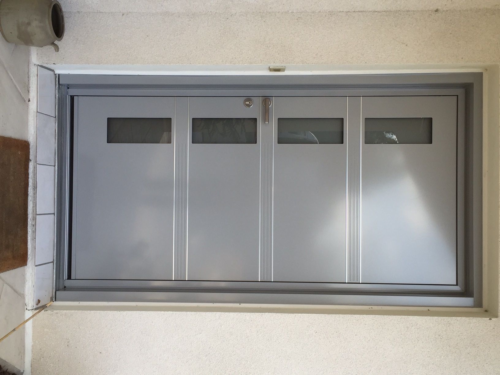 Une porte grise en aluminium.