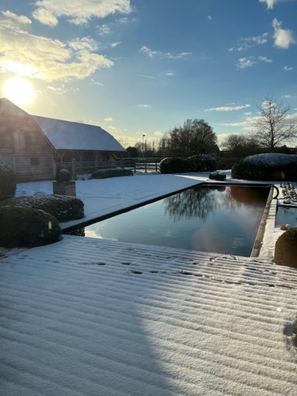 een huis en een vijver in een tuin
