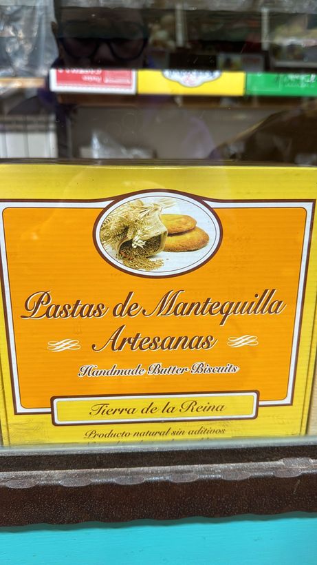 A box of pastros de mantequilla artesanal is sitting on a table.