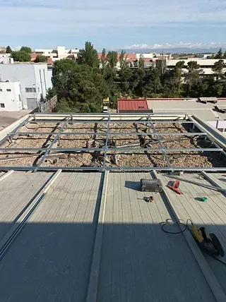 Un techo con una estructura de metal que se construye sobre él.