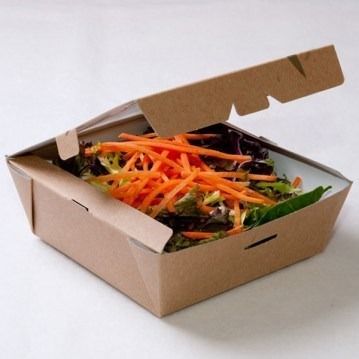 Una caja de cartón llena de zanahorias y lechuga