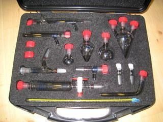 Un maletín lleno de una variedad de instrumentos de vidrio.