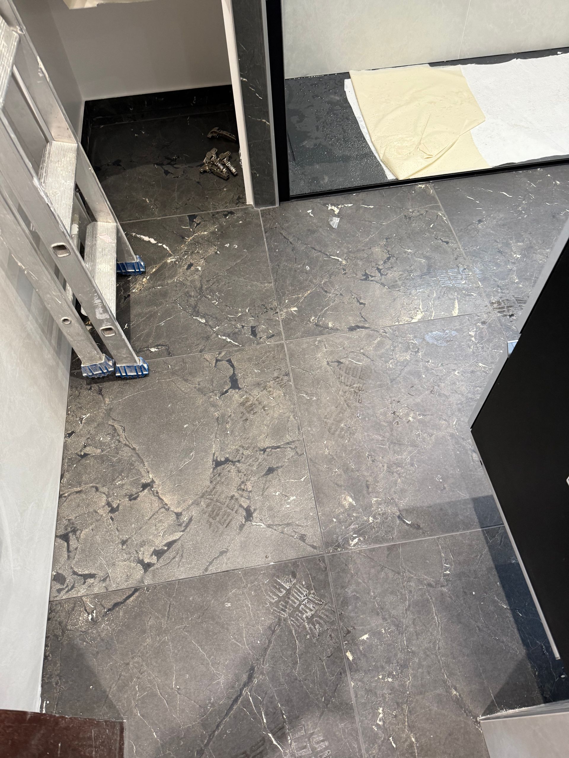 Sol de salle de bain en cours de rénovation avec outils visibles