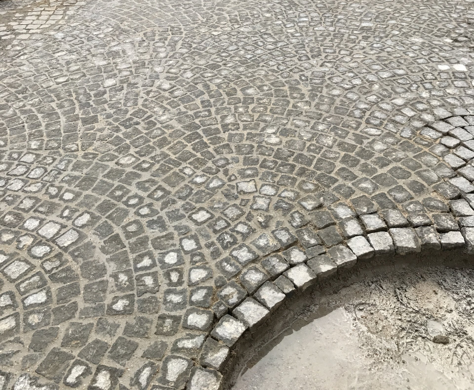 Finition d'un sol décoré avec des petits pavés carrés