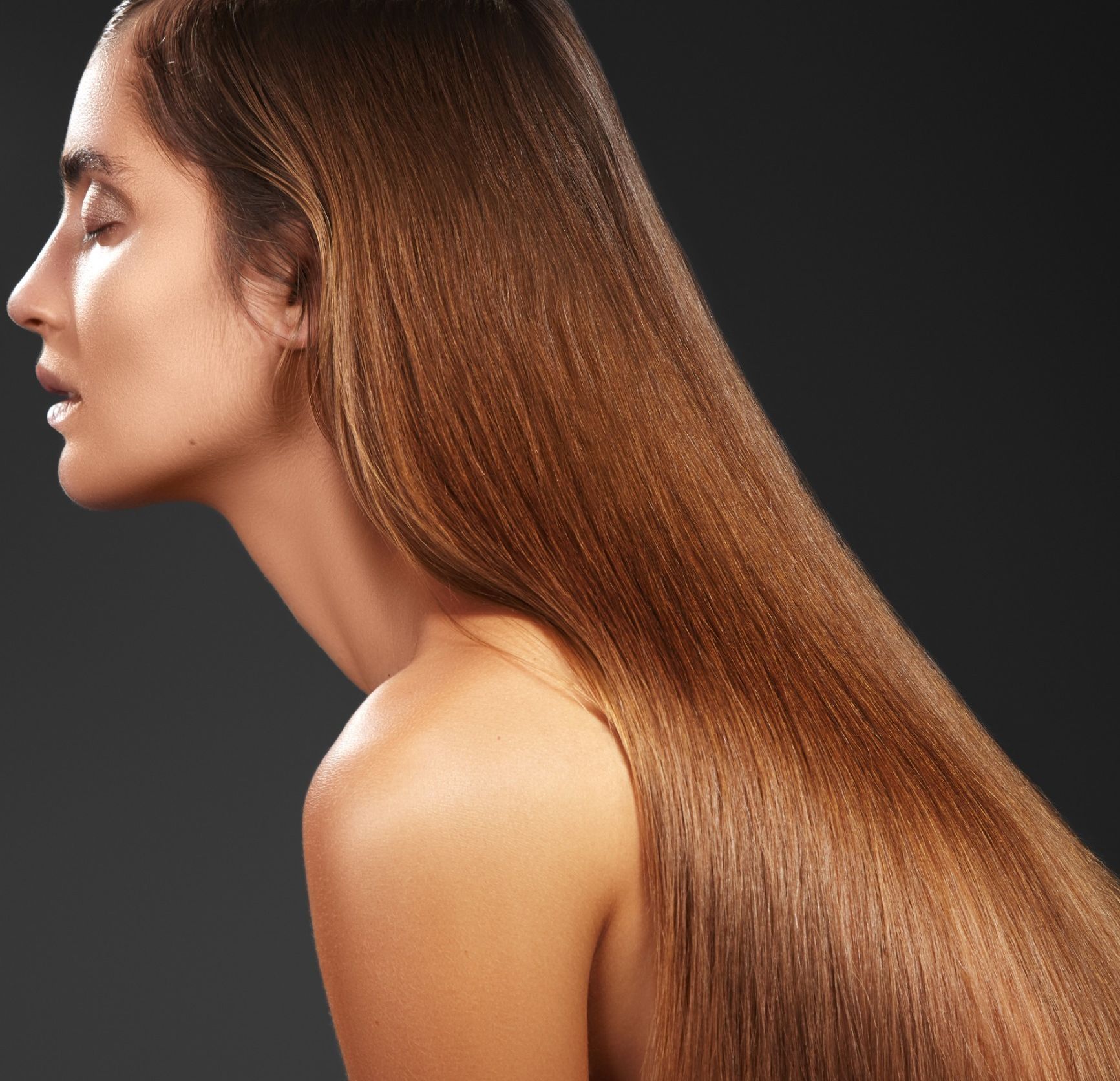 Se muestra de lado a una mujer con cabello castaño muy largo.