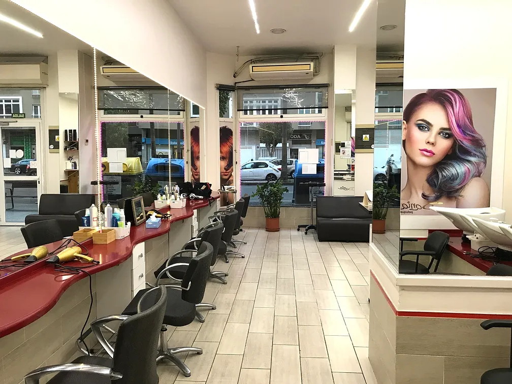 Una peluquería con una foto de una mujer en la pared.
