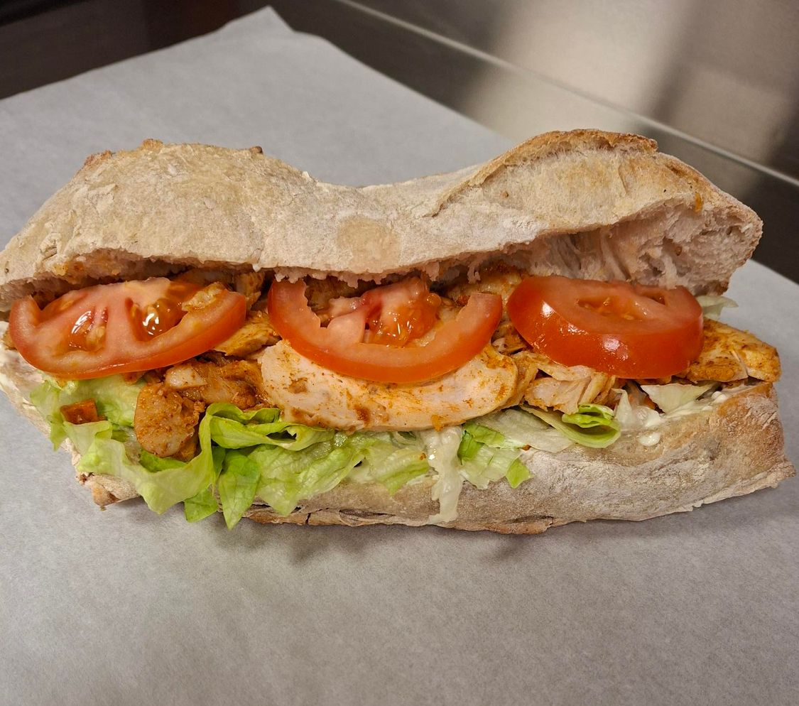 photorealistic worker enjoying a fresh sandwich outside in a sunny park close up focus on food