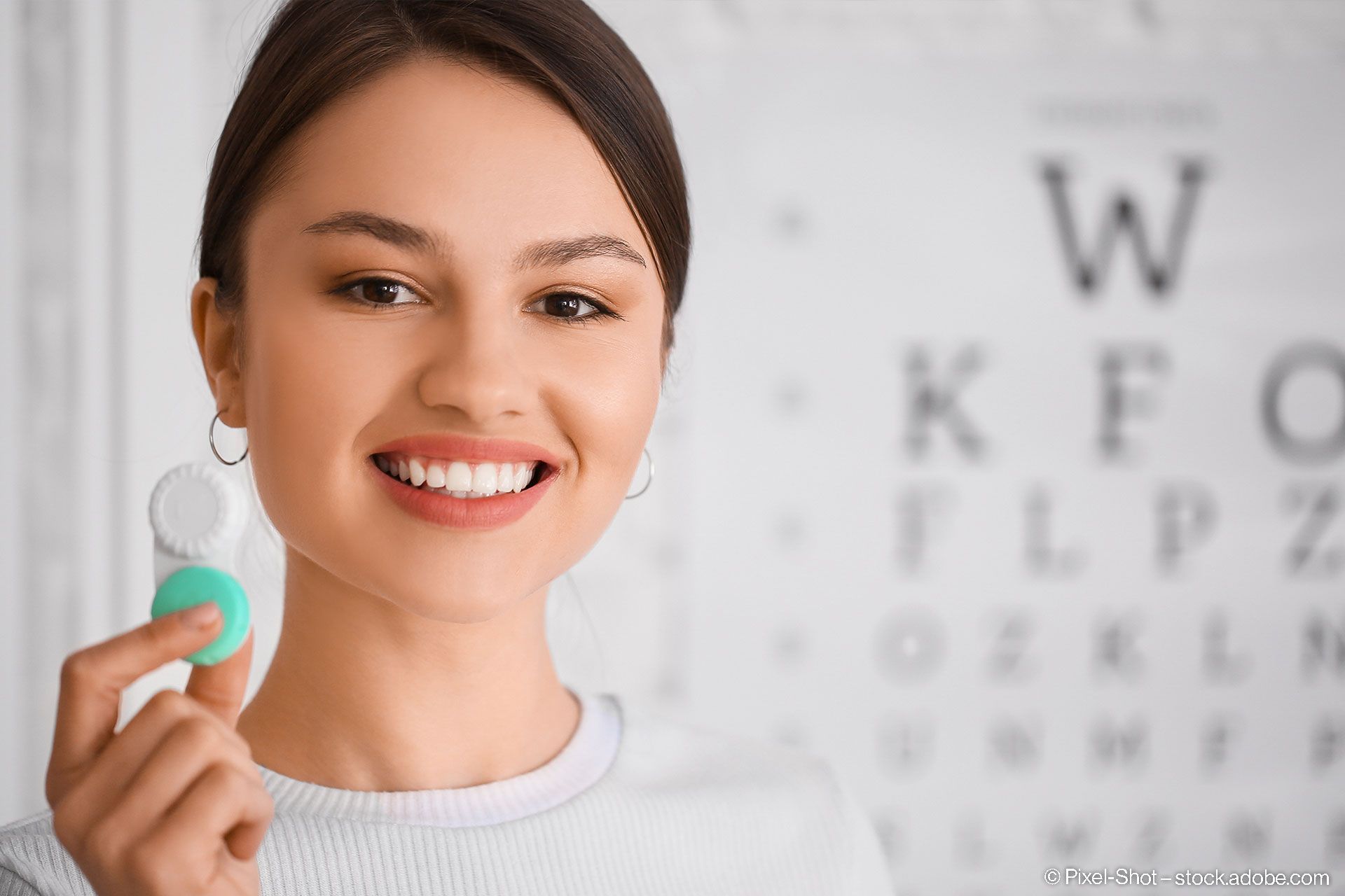 Junge Frau mit Kontaktlinsen in der Augenarztpraxis