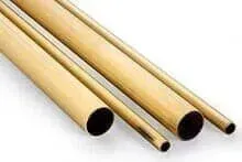 Três tubos de latão estão empilhados um sobre o outro em uma superfície branca.