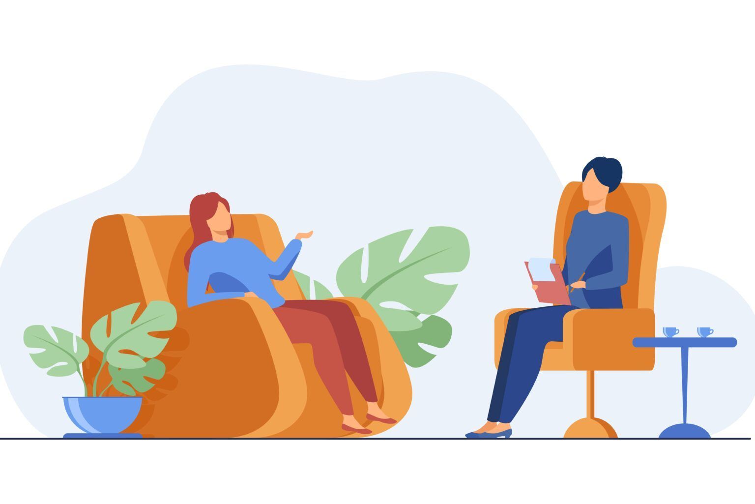 Dos personas sentadas en cómodos sillones conversando en una habitación con una planta en maceta y una pequeña mesa auxiliar.