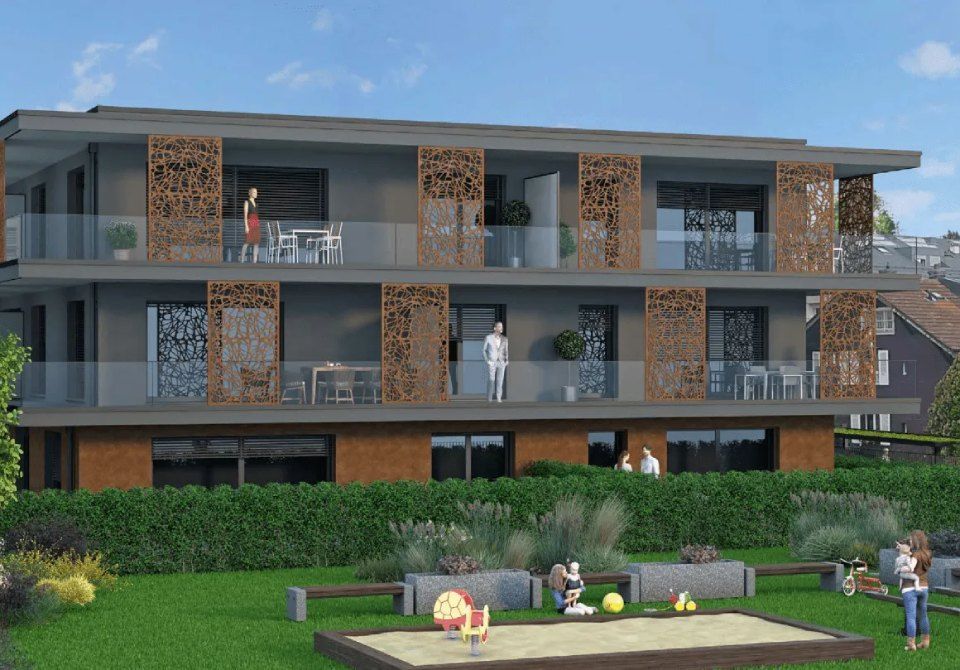 Une impression d'artiste d'un bâtiment avec un bac à sable devant lui.