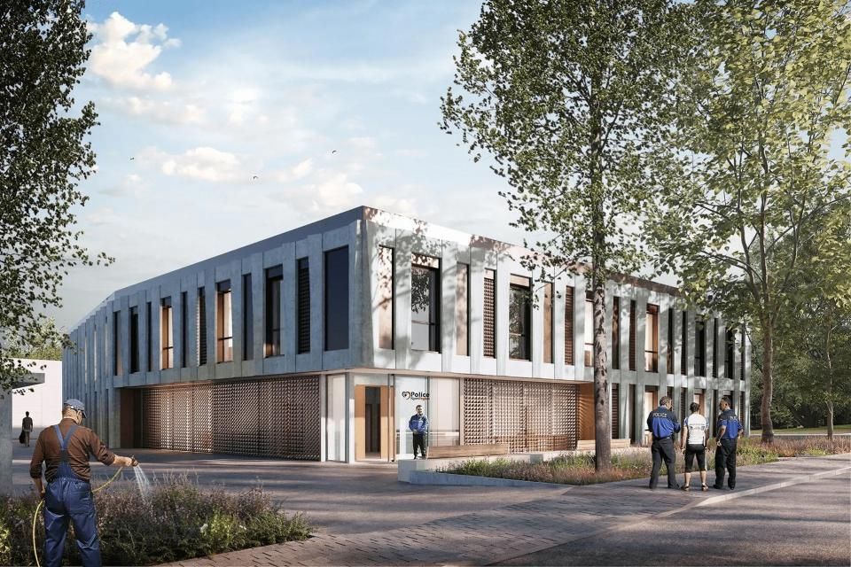 Un groupe de personnes se tient devant un grand bâtiment.