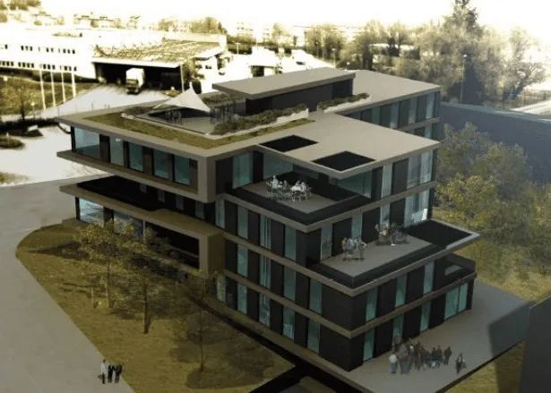 Une vue aérienne d'un grand bâtiment avec un toit vert