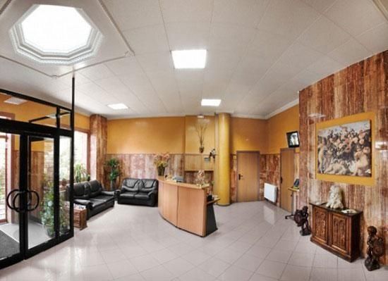 Una habitació gran amb un sofà i un quadre a la paret