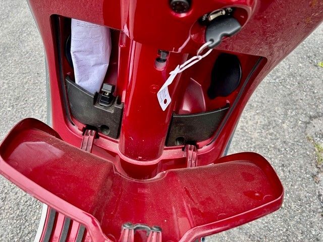 Ein roter Roller mit einem weißen Schild daran