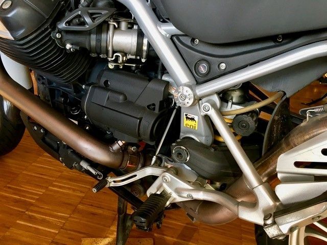 Eine Nahaufnahme eines Motorradmotors auf einem Holzboden