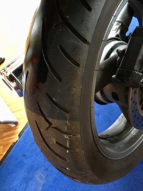 Eine Nahaufnahme eines Motorradreifens auf einer blauen Matte