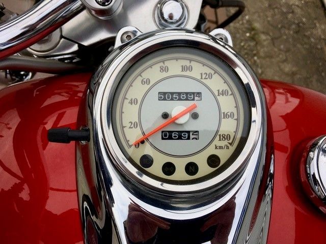 Eine Nahaufnahme eines Tachometers auf einem roten Motorrad