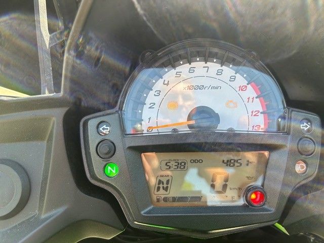 Motorrad-Armaturenbrett mit Tachometer, Digitalanzeige und grün und rot leuchtenden Kontrollleuchten