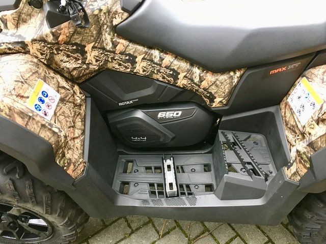 Ein getarntes ATV ist auf einem Ziegelpflaster geparkt