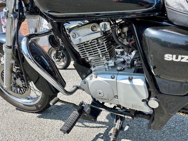 Ein schwarzes Suzuki-Motorrad ist am Straßenrand geparkt