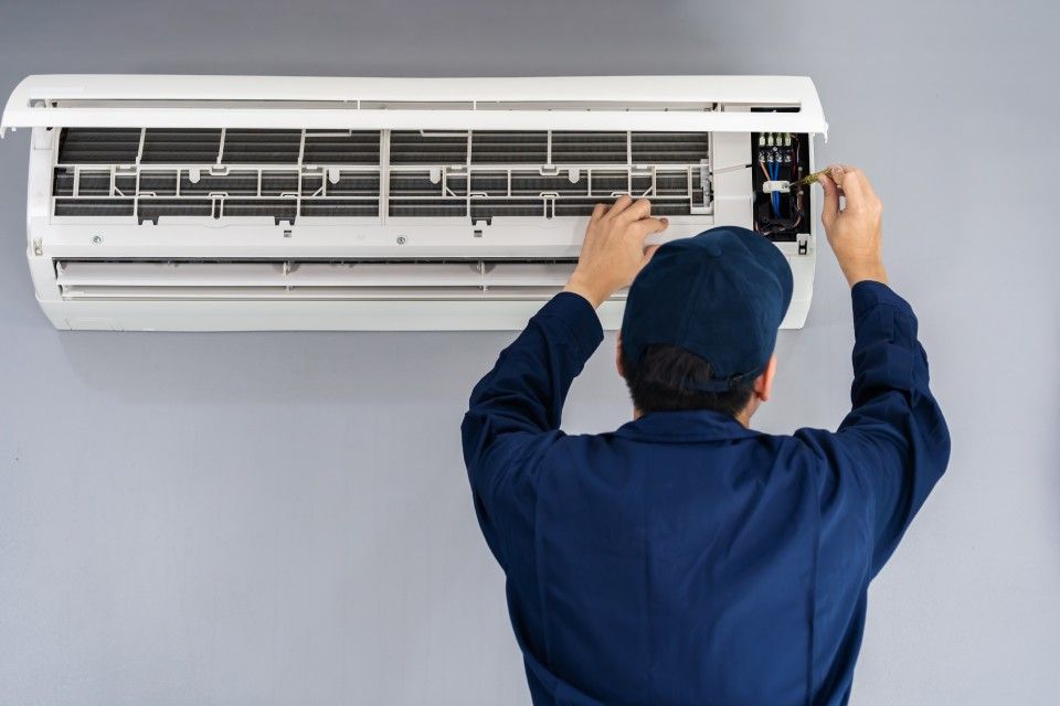 Mitarbeiter der Cityclima Kälte- & Klimatechnik GmbH installiert Klimaanlage