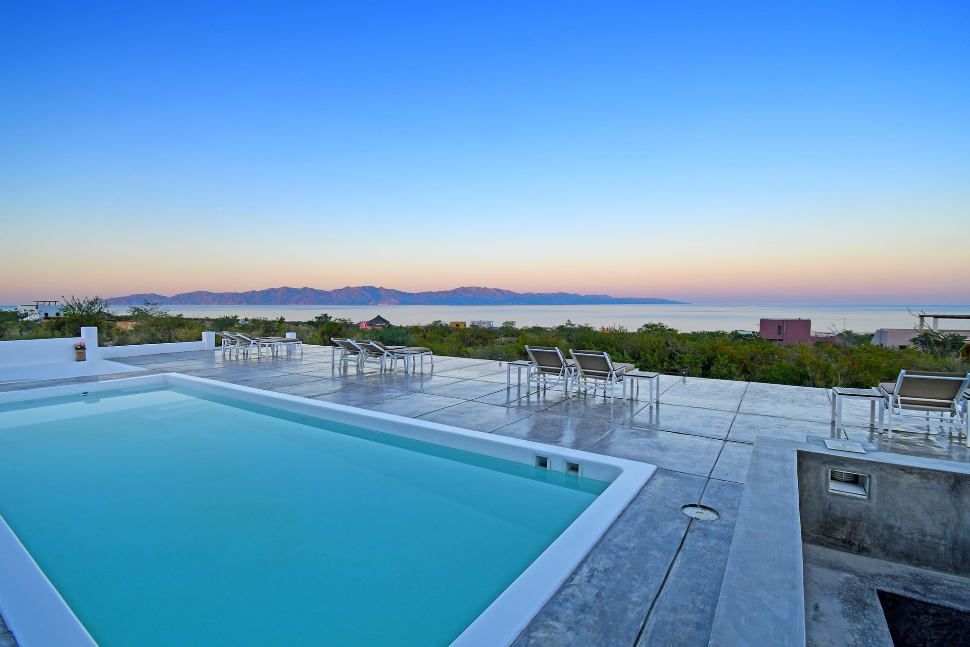 A large swimming pool with a view of the ocean