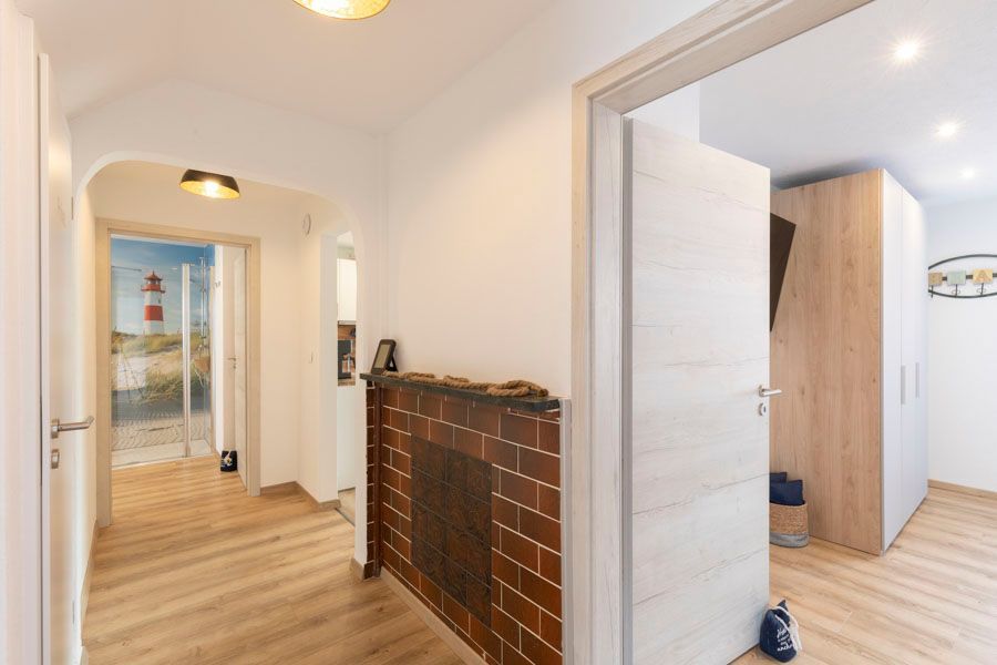 Ein Flur mit gemauertem Kamin und einem Leuchtturm an der Wand.