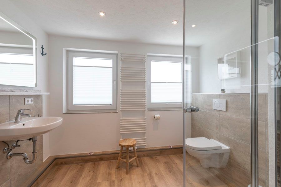 Ein Badezimmer mit Toilette, Waschbecken und Spiegel.