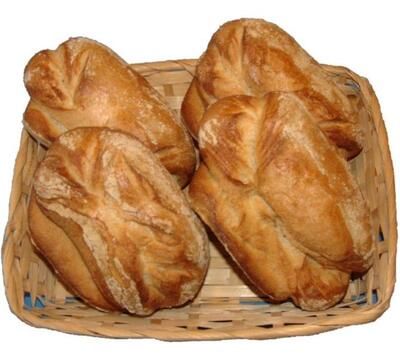 Vier Brote liegen in einem Weidenkorb