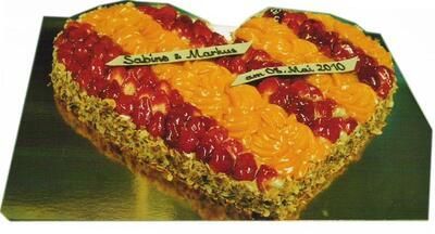 Ein herzförmiger Kuchen mit Erdbeeren und Orangenglasur