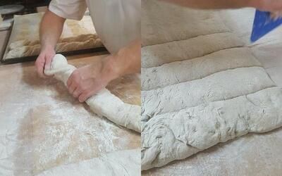 Eine Person backt auf einem Tisch einen Laib Brot.