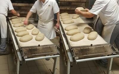 Eine Gruppe von Menschen backt in einer Bäckerei Brot auf einem Förderband.
