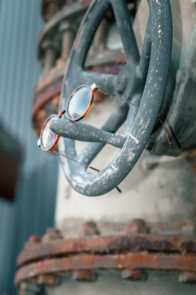 Eine Sonnenbrille hängt an einem rostigen Rohr.