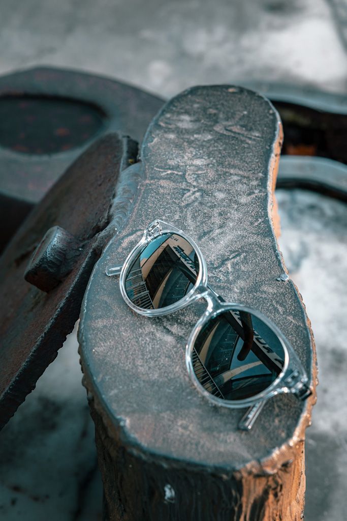 Eine Sonnenbrille liegt auf einem Holzstumpf.